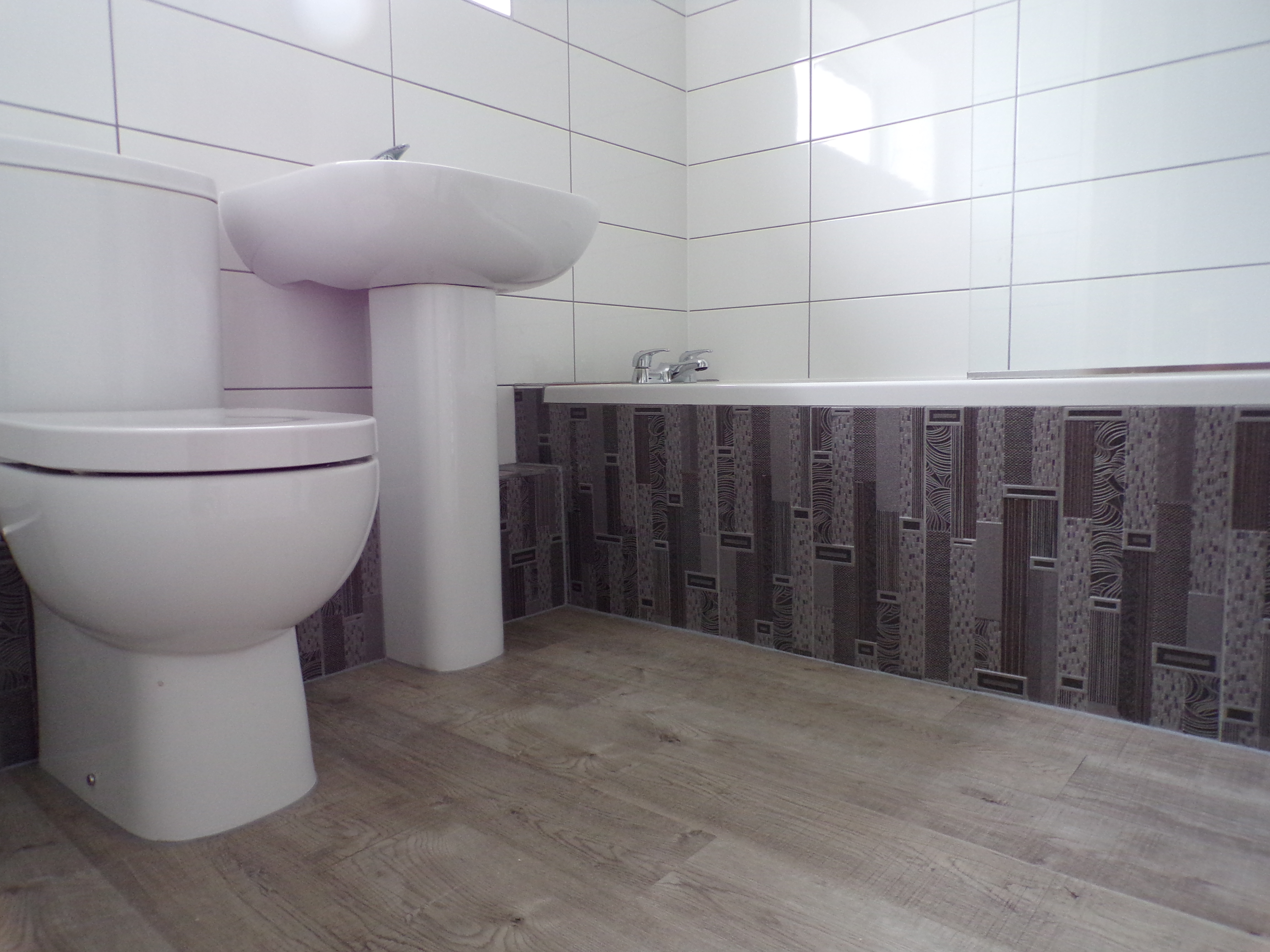 White tiles with feature decors and grey grout
